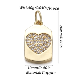 Macro shot of gold copper heart pendant with zircon inlay and product dimensions