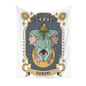 Detailed macro of Gemini zodiac tapestry featuring sun, moon phases and crystal motifs