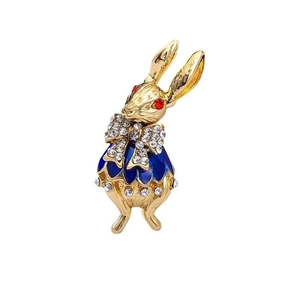 Detail of cute rabbit brooch in gold with blue enamel dress and sparkling rhinestones