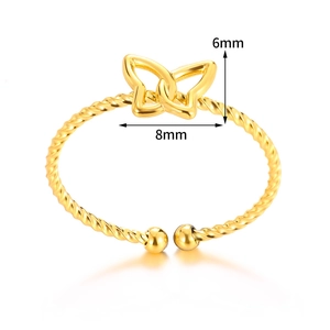 Detail of twisted gold bangle featuring butterfly heart motif with 6mm by 8mm dimensions