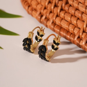 Detailed view of U-shaped wheat ear earrings with black gems and golden base