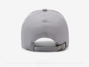 Detail view of the gray twill baseball cap with a branded metal adjustable back strap buckle