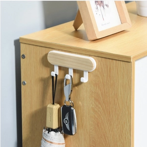 Detail of wooden wall-mounted rack with four hooks holding a folding umbrella and keys