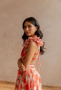 Detail of ruffle neckline and orange floral print on backless bohemian maxi dress