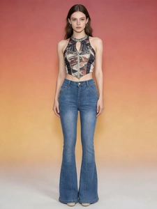 Low-rise vintage flared jeans paired with a colorful retro print halter top for women