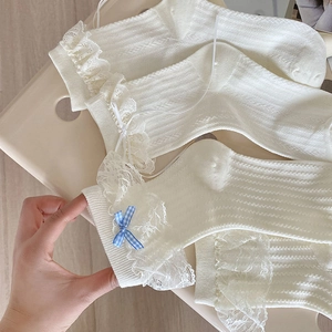 White lace socks with sweet blue bows and frilly trim for ballet style fashion look