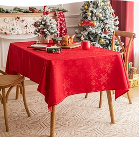 Macro detail of red Christmas tablecloth with snowflake jacquard in festive home dining setting