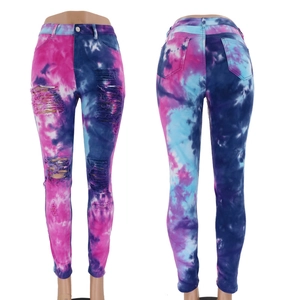 Slim fit tie-dye denim jeans with distressed holes, front and back view on white background