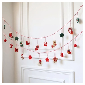 Detailed view of handmade wool felt Christmas garland with gingerbread man and snowman