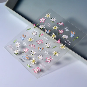 5D embossed lily and butterfly nail stickers with realistic 3D textures on a light blue tray