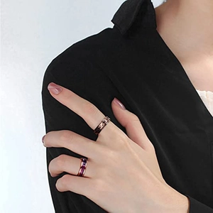 Detailed view of rose gold fidget rings featuring sun moon and star motifs on hand