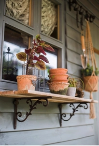 Close-up of European retro cast iron shelf brackets with elegant scroll leaf pattern