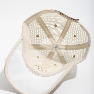Macro detail of breathable mesh fabric and reinforced inner seams on a kids beige sun hat