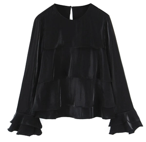 Detail view of black layered satin blouse with ruffle sleeves and smooth glossy texture