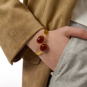 Gold-plated titanium steel open bangle featuring two large oval red agate stones