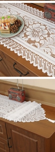 Detail of white lace table runner featuring floral crochet patterns and tassel fringe