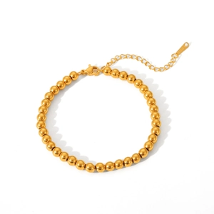 Macro view of 18k gold plated beaded bracelet with lobster clasp and adjustable chain