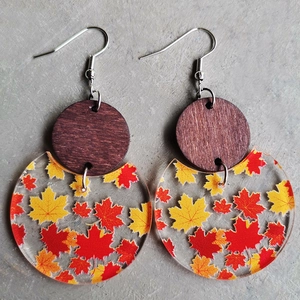 Handmade wooden and acrylic drop earrings featuring embedded autumn maple leaf patterns