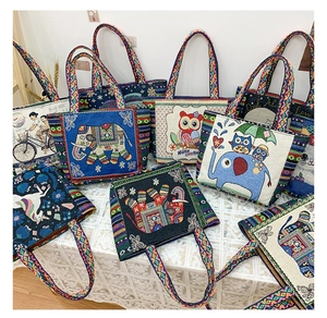 Close-up of ethnic woven handbags with colorful bohemian patterns and braided handles