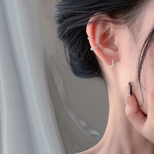 Elegant S999 sterling silver hoop earrings with cubic zirconia on female model