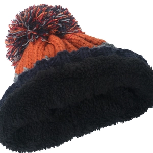 Detail of winter knit hat featuring colorful stripes and thick fleece lining for warmth