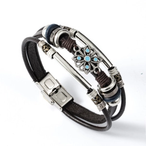 Macro shot of multilayer leather bracelet with floral metal bead and blue turquoise stone