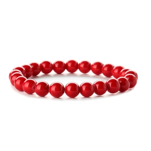 Minimalist red natural stone beaded bracelet with polished round beads on white background