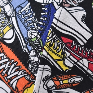 Macro shot of durable canvas fabric featuring colorful hand-drawn sneaker illustrations