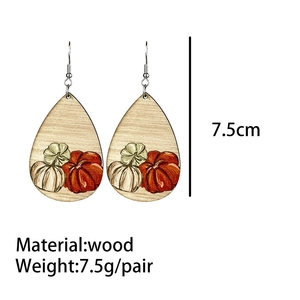 Detail showing 7.5cm length and weight of these wooden pumpkin teardrop earrings