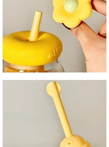 Detail of yellow tea filter chamber with donut-shaped lid and cute flower straw decor