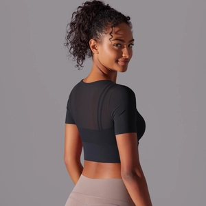 Close-up of black mesh patchwork on the back of this breathable cropped yoga top