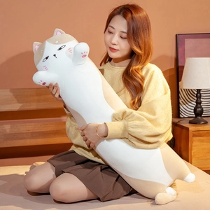 Detailed embroidery facial expression on long cat plush pillow in warm bedroom setting