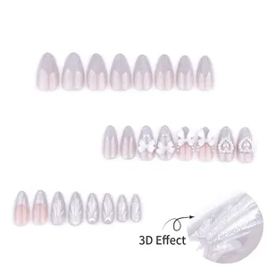 Faux ongles amande avec nœuds 3D et perles, dégradé violet brillant et effet œil de chat