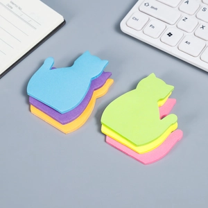 Cute cat-shaped sticky notes in colorful packs on a professional office desk background