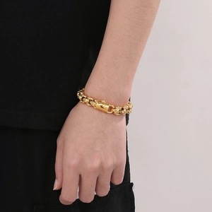 Detail shot of heavy golden stainless steel punk chain bracelet on male wrist