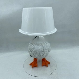Macro detail of the creative white duck night light showing life-like base and orange feet