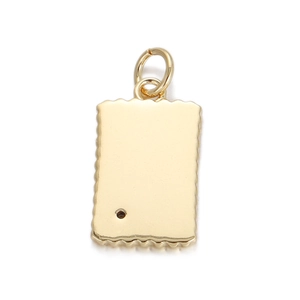 Macro detail of 18K gold plated rectangular pendant with scalloped edges and polished finish