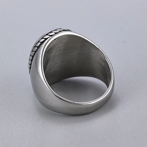 Detailed top view of retro silver stainless steel ring with braided edge texture