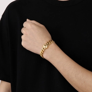 Close-up of 11mm gold-plated titanium Cuban chain with sparkling diamond-set buckle