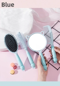 Blue rabbit hairbrush and mirror set with cute cat ear details on pink silk background