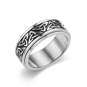 Macro shot of silver Celtic knot spinner ring with inner brushed stainless steel texture