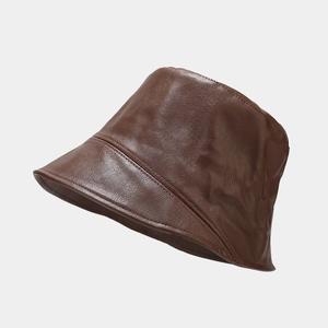 Close-up of brown PU leather bucket hat showing detailed texture and retro style