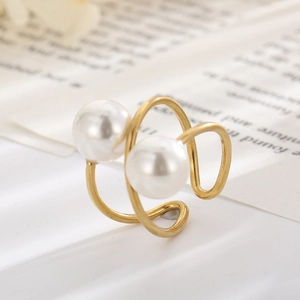 Macro shot of double pearl spiral ring in gold metal finish with polished texture