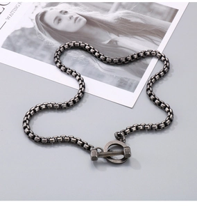 Detail of vintage silver-tone barbell OT clasp on stainless steel cuban chain necklace