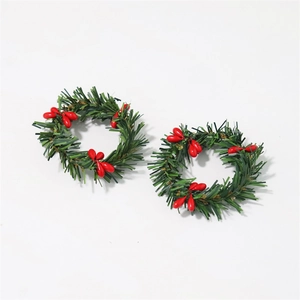 Macro view of Christmas napkin rings featuring green pine needles and red berries