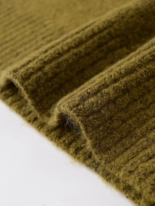Close-up of moss green chunky knit sweater fabric with soft brushed mohair texture