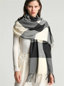 Detail of grey and black checkered cashmere-like scarf with soft fringe edges