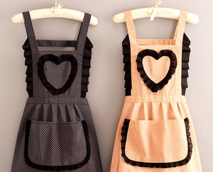 Detail view of canvas aprons with dot patterns, heart ruffles, and front storage pockets