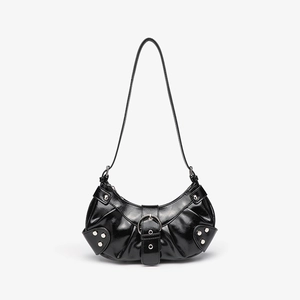 Detail of glossy black hobo bag featuring silver rivets and metal buckle hardware