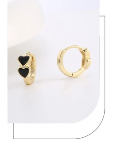 Macro shot of S925 sterling silver stamp on golden double heart drop earrings